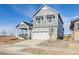 Two-story house with gray siding, stone accents, and a two-car garage at 24955 E 41St Ave, Aurora, CO 80019