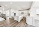 Open concept kitchen with white cabinets, large island, and stainless steel appliances at 24955 E 41St Ave, Aurora, CO 80019