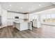 Open concept kitchen with white cabinets, large island, and stainless steel appliances at 24955 E 41St Ave, Aurora, CO 80019