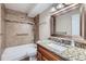 Bathroom featuring tile, shower with handrails, vanity, and granite countertop at 350 S Clinton St # 9B, Denver, CO 80247