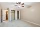 Large bedroom with bi-fold closet doors and ceiling fan at 350 S Clinton St # 9B, Denver, CO 80247