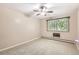 Bedroom with neutral carpet, a ceiling fan, and a large window for natural light and views at 350 S Clinton St # 9B, Denver, CO 80247