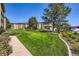 Manicured lawn with mature trees creates a park-like setting around the building at 350 S Clinton St # 9B, Denver, CO 80247