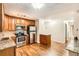 The kitchen has stainless steel appliances, granite countertops, updated lighting, and beautiful oak cabinets at 350 S Clinton St # 9B, Denver, CO 80247