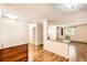 Bright living room with wood floors, neutral walls, and a breakfast bar with granite countertop at 350 S Clinton St # 9B, Denver, CO 80247