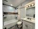 Modern bathroom featuring a shower-over-tub, modern tiles, and black fixtures at 16800 E Bails Pl, Aurora, CO 80017