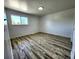 This bedroom features wood-look flooring and a window providing natural light at 16800 E Bails Pl, Aurora, CO 80017