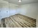 This bedroom showcases neutral walls, wood-look flooring, and a double door closet at 16800 E Bails Pl, Aurora, CO 80017