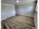 This bedroom showcases neutral walls, wood-look flooring, and a double door closet at 16800 E Bails Pl, Aurora, CO 80017
