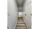 Hallway features a modern design with wood-look flooring and white doors at 16800 E Bails Pl, Aurora, CO 80017
