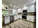 Kitchen with stainless steel appliances, granite counters, and white cabinets with sleek hardware at 16800 E Bails Pl, Aurora, CO 80017
