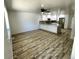Open-concept living room with wood-look floors, white walls, new cabinets and countertops at 16800 E Bails Pl, Aurora, CO 80017