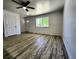 Spacious living area featuring wood-look flooring, ceiling fan and a view of the outdoor landscaping at 16800 E Bails Pl, Aurora, CO 80017