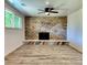 Cozy living room with a stone fireplace, ceiling fan, and hardwood flooring at 16800 E Bails Pl, Aurora, CO 80017