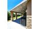 Covered patio with wooden plank ceilings, stone pillars, and an AC unit at 16800 E Bails Pl, Aurora, CO 80017