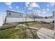 Well-maintained backyard features a white fence, lush green grass, and mature trees for a serene outdoor space at 5202 Cathay St, Denver, CO 80249