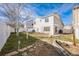 The home's backyard with tidy landscaping is ready for outdoor entertaining and relaxation at 5202 Cathay St, Denver, CO 80249