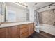 Bathroom featuring a vanity, toilet, tub and shower with decorative tile at 5202 Cathay St, Denver, CO 80249