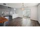 Open dining room with wood floors and sliding glass doors to the outside at 5202 Cathay St, Denver, CO 80249