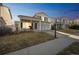 Charming gray two-story home with covered porch and well-maintained lawn at 5202 Cathay St, Denver, CO 80249