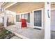 Inviting front porch with a comfortable red chair, offering a relaxing outdoor seating area at 5202 Cathay St, Denver, CO 80249