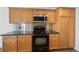 Modern kitchen with stainless steel microwave and oven complemented by sleek black countertops at 5202 Cathay St, Denver, CO 80249