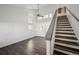 Bright living room with soaring ceilings, modern floors, and staircase at 5202 Cathay St, Denver, CO 80249