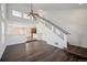 Open-concept living area featuring hardwood floors, high ceilings, and modern staircase at 5202 Cathay St, Denver, CO 80249