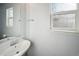 Bright powder room featuring a pedestal sink and window providing natural light at 5202 Cathay St, Denver, CO 80249