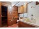 A bathroom with a bathtub and wood panels all around it at 2308 Hearth Dr # 28, Evergreen, CO 80439