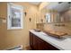 A bathroom with a big mirror, two sinks and a window at 2308 Hearth Dr # 28, Evergreen, CO 80439