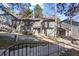 A view of a multi-story townhome with gray siding and balcony at 2308 Hearth Dr # 28, Evergreen, CO 80439