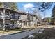 A townhouse with vertical wood siding has a small balcony and a covered front entryway at 2308 Hearth Dr # 28, Evergreen, CO 80439