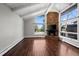 Living room with a stone fireplace, large windows, hardwood floors, and vaulted ceiling at 2308 Hearth Dr # 28, Evergreen, CO 80439