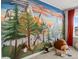 Bedroom with a hand painted mountain mural, large stuffed animals, and a side window at 800 Boulder Peak Ave, Erie, CO 80516
