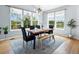 Sunlit dining area featuring a modern chandelier, table with seating, and backyard views at 800 Boulder Peak Ave, Erie, CO 80516