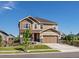 Charming two-story home with a well-manicured lawn, craftsman details, and an attached garage at 800 Boulder Peak Ave, Erie, CO 80516