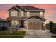 Charming two-story home featuring a two-car garage, covered porch, and beautifully landscaped front yard at 800 Boulder Peak Ave, Erie, CO 80516