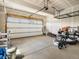 Spacious garage with high ceilings, storage racks, and a modern garage door at 800 Boulder Peak Ave, Erie, CO 80516