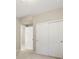 Hallway view with gray carpet and a closet with sliding doors at 800 Boulder Peak Ave, Erie, CO 80516