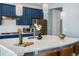 Stylish kitchen featuring quartz island, stainless steel appliances, and modern lighting at 800 Boulder Peak Ave, Erie, CO 80516