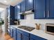 Modern kitchen showcasing stainless steel appliances, stylish range hood, and subway tile backsplash at 800 Boulder Peak Ave, Erie, CO 80516