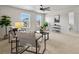 Bright living room filled with natural light, neutral furniture and views from large windows at 800 Boulder Peak Ave, Erie, CO 80516