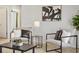Cozy living area featuring two chairs, modern art, and easy access to the rest of the home at 800 Boulder Peak Ave, Erie, CO 80516