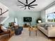 Cozy living room with hardwood floors, modern ceiling fan, and neutral color scheme at 800 Boulder Peak Ave, Erie, CO 80516
