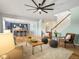 Open-concept living room flows into a stylish kitchen with blue cabinets and a breakfast bar at 800 Boulder Peak Ave, Erie, CO 80516