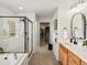 The main bathroom features double sinks, walk-in shower, and custom tile work at 800 Boulder Peak Ave, Erie, CO 80516