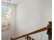 Staircase with wood railing, pendant lighting, and a view from the window at 800 Boulder Peak Ave, Erie, CO 80516
