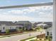 Neighborhood street featuring well-maintained homes, green lawns, wooden fences and mountain views at 800 Boulder Peak Ave, Erie, CO 80516