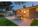 Brick home's backyard has patio, a well maintained lawn and sliding doors into the kitchen at 10844 W 68Th Ave, Arvada, CO 80004